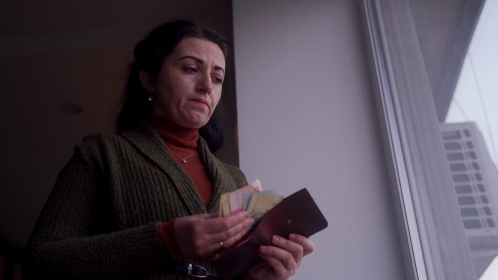 concerned-woman-inspects-empty-wallet