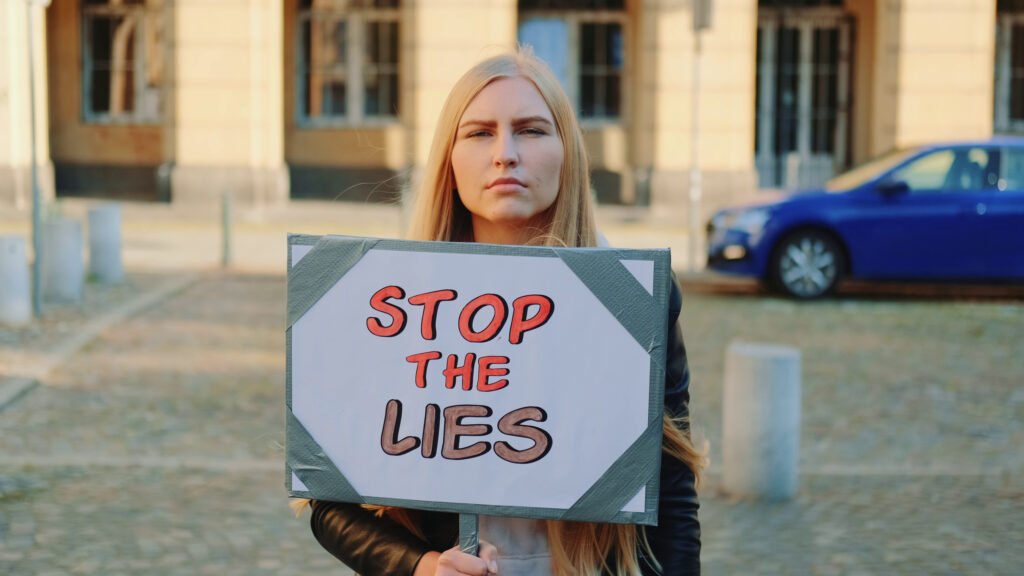 concerned-woman-with-protest-banner-calling-to-stop-lies