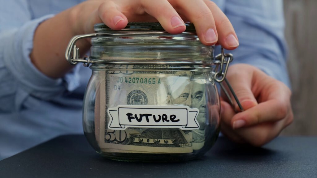 female-hands-add-money-to-saving-money-in-jar-filled-with-dollars-banknotes-future