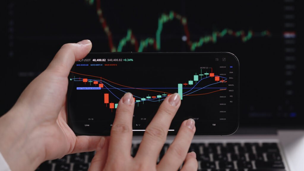 person on phone trading stocks