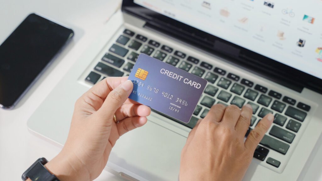 woman-hands-holding-credit-card-and-using-laptop-with-product-purchase-at-home